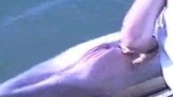 Curious man gently stimulates hole of sea animal with his hand