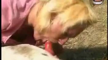 Blonde babe in pink gives head to a dog and then gets pounded