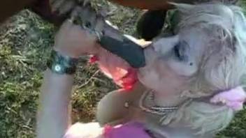 Naughty curvy blonde BBW blows enormous horse cock outdoors