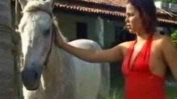 Long-legged zoofil in red dress fuck with a white pony