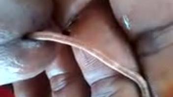 African American guy employs an elongated worm for enhanced self-arousal.