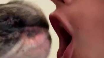 Alluring woman passionately kisses a dog in steamy oral adult video sequences