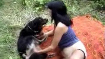 Dark-haired woman gives head to a canine before outdoor screwing